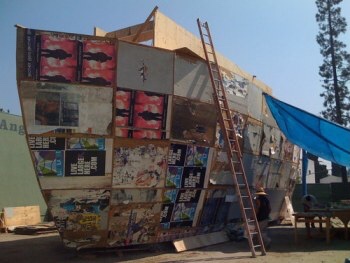 In 2008, Bradford created a large-scale sculpture for 'Prospect 1: New Orleans Biennial'. 'Mithra', a three-storey 'ark' made from stacked shipping containers, was made on a vacant plot in the Lower Ninth Ward, one of the areas most devastated by Hurricane Katrina in 2005. Covered in battered poster boards and advertising found around the city in the wake of the disaster, the sculpture appeared as both sepulchral monument and symbol of renewal. Bradford's film 'Across Canal' charts the making of 'Mithra', pointing to the relationship of the sculpture to the physical neighbourhood and its inhabitants. Shot on Super-8, the provisional techniques of handheld camerawork, bleached out images and jump cut editing give it a dreamy, timeless quality. https://whitecube.com/exhibitions/exhibition/mark_bradford_hoxton_square_2010